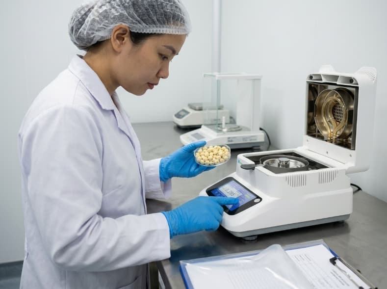Water Activity Below 0.3: The Number That Protects Lotus Seed Shelf Life qa specialist testing freeze dried lotus seed water activity with benchtop meter in lab.